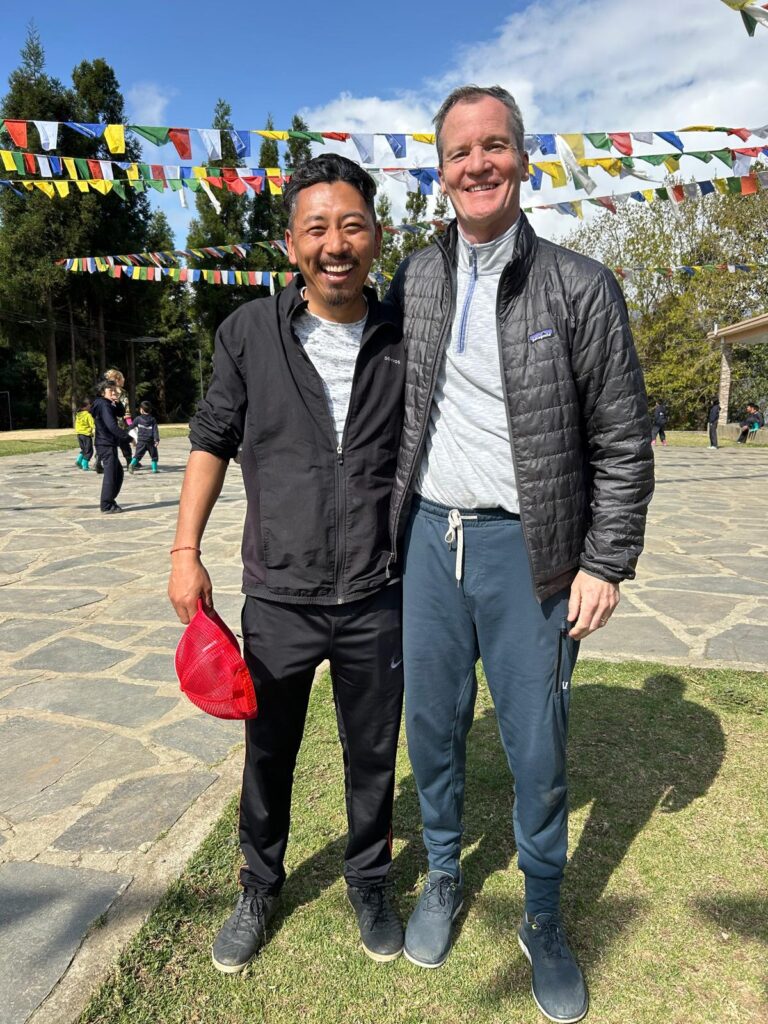Mark with Jhamtse Gatsal's Headteacher Tenzin Dondul.